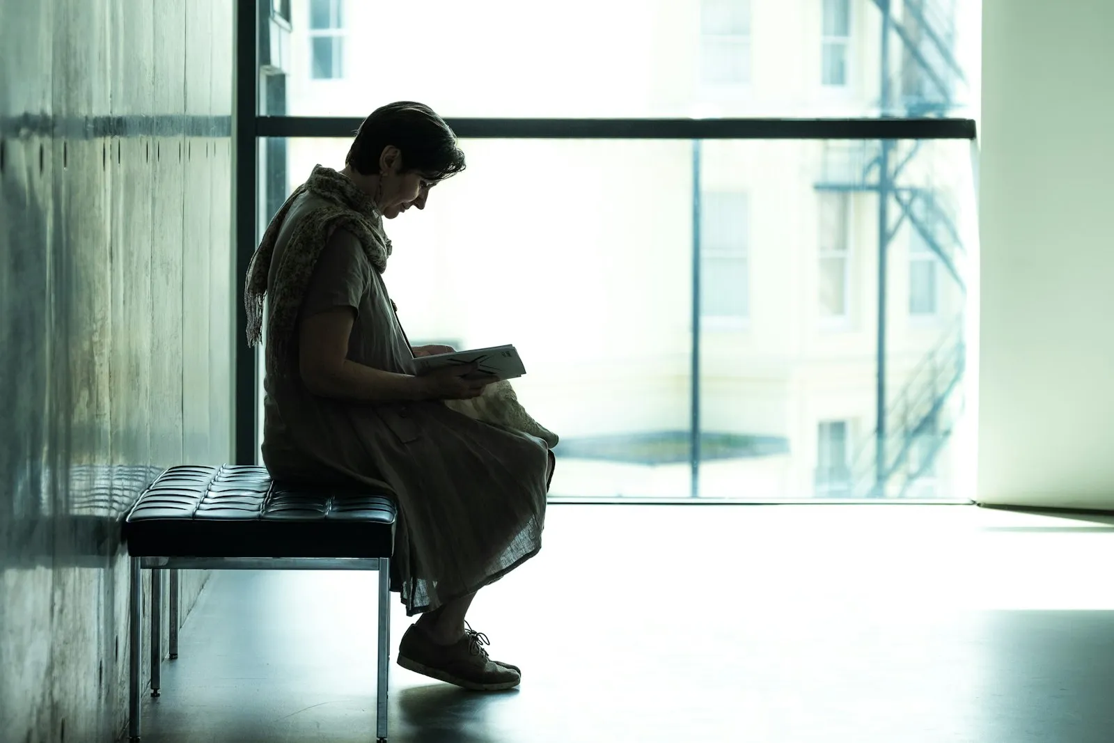 A person reading by a window